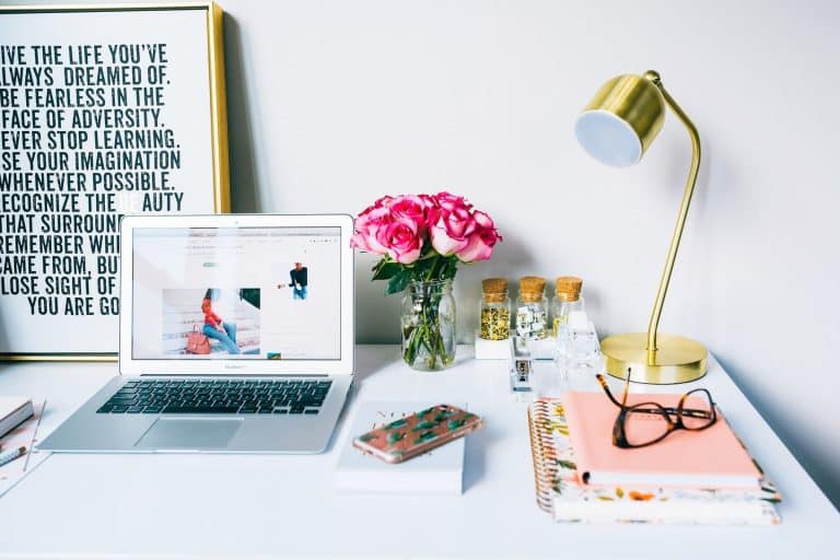A Desk with a Computer, Florals and a Notebook | 7 Essential Ways to Transform Your Website to Work for You
