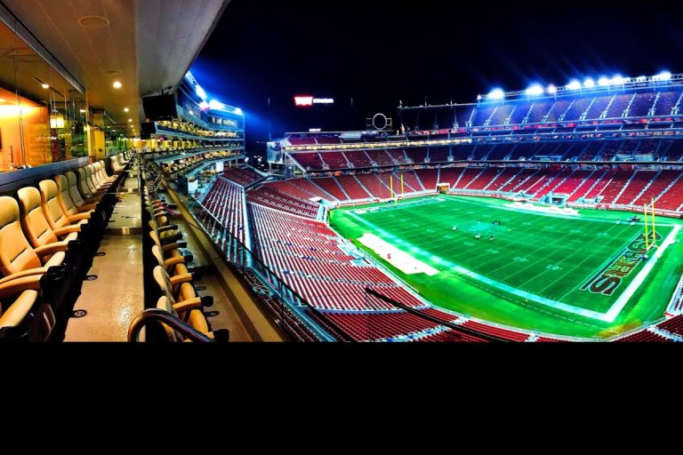 A panoramic night view of Levi's Stadium in Santa Clara, highlighting vibrant lights.